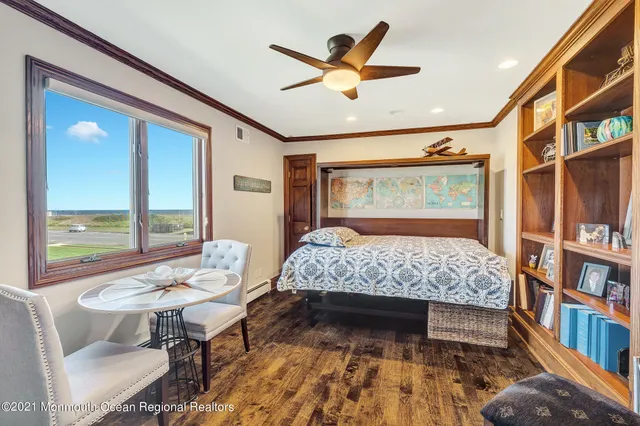 a bedroom with a large bed and a bookshelf