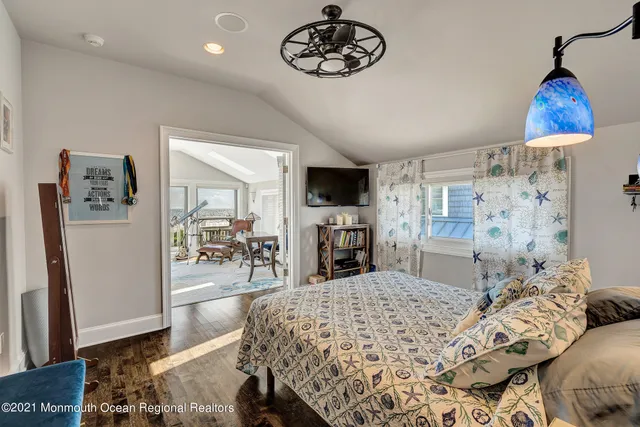 a bedroom with a bed and a television