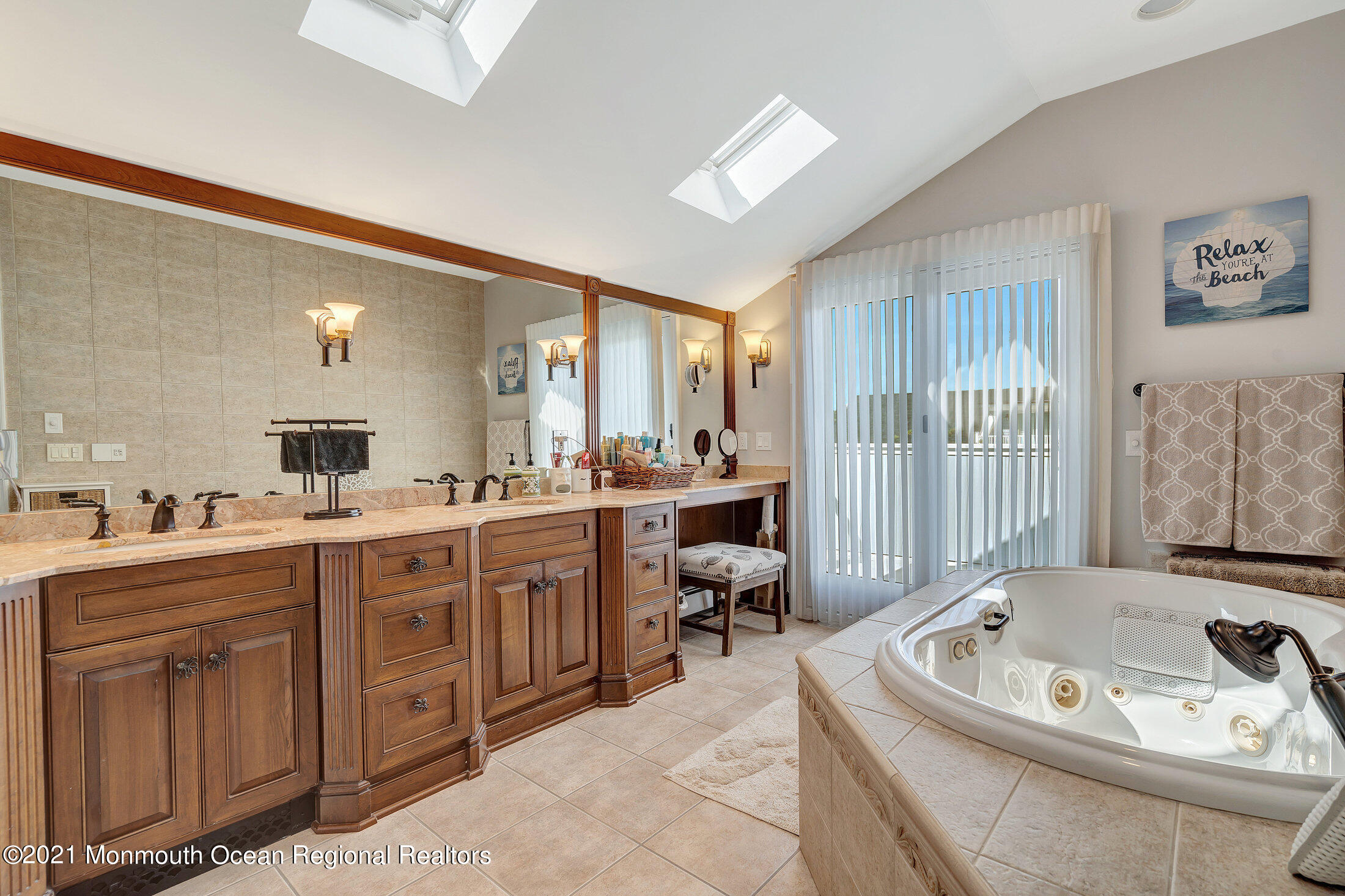 211 North Ocean Avenue Spring Lake, NJ 07762 - Photo 27 of 44 a spacious bathroom with a double vanity sink tub and mirror