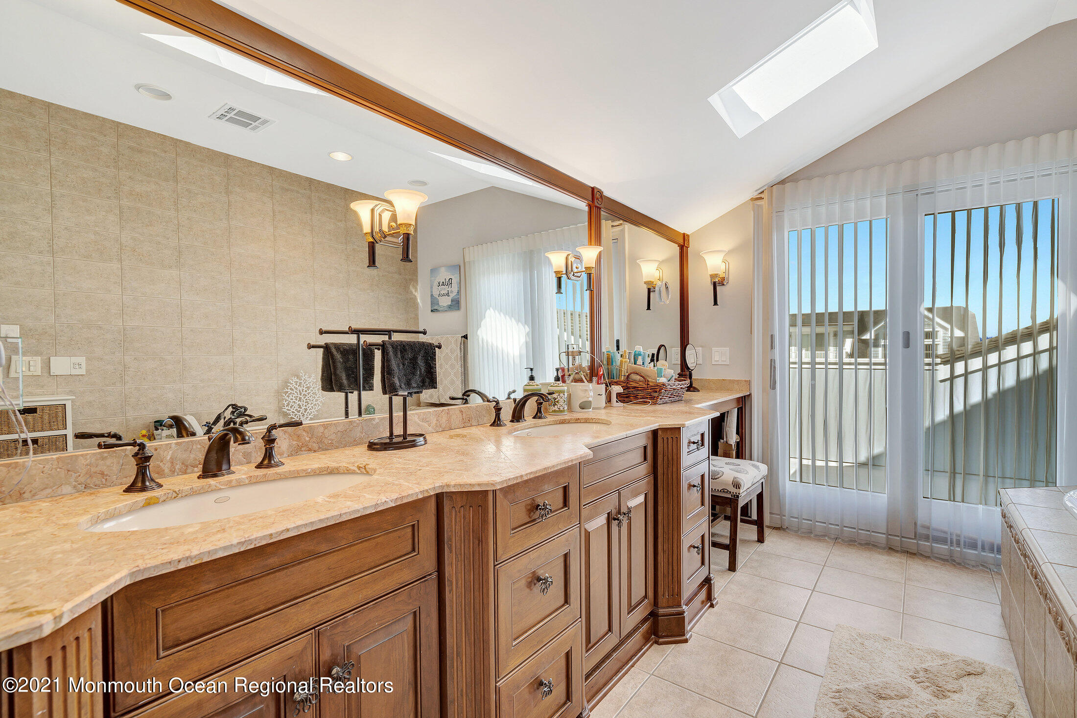 211 North Ocean Avenue Spring Lake, NJ 07762 - Photo 28 of 44 a spacious bathroom with a double vanity sink a mirror and a shower