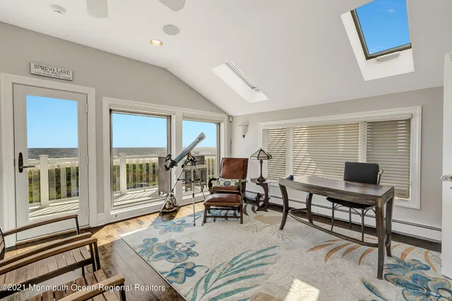 a living room with furniture a rug and a window