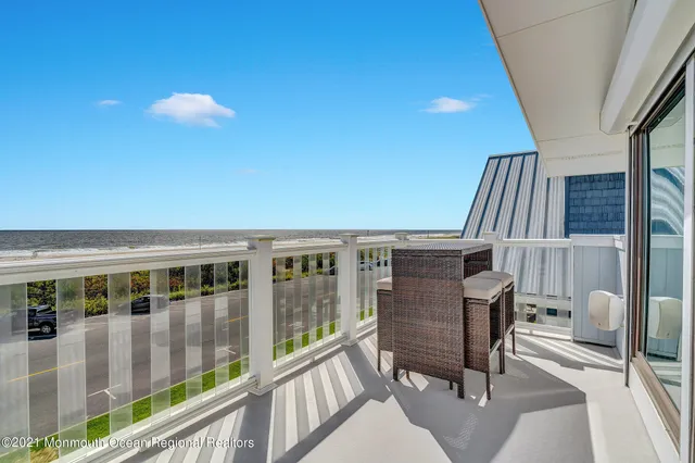 a view of balcony with a potted plant and outdoor seating