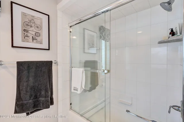 a bathroom with a shower and a sink