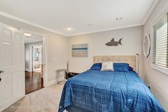 a bedroom with a large bed and a wooden floor