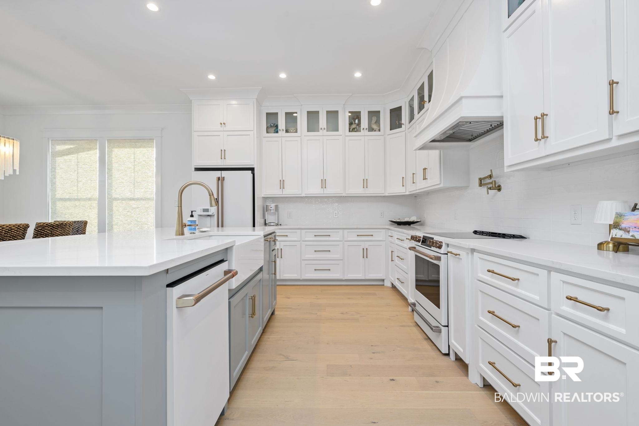 30313 River Road Orange Beach, AL 36561 - Photo 15 of 50 Kitchen with glass insert cabinets, light stone countertops, white appliances, white cabinets, and recessed lighting