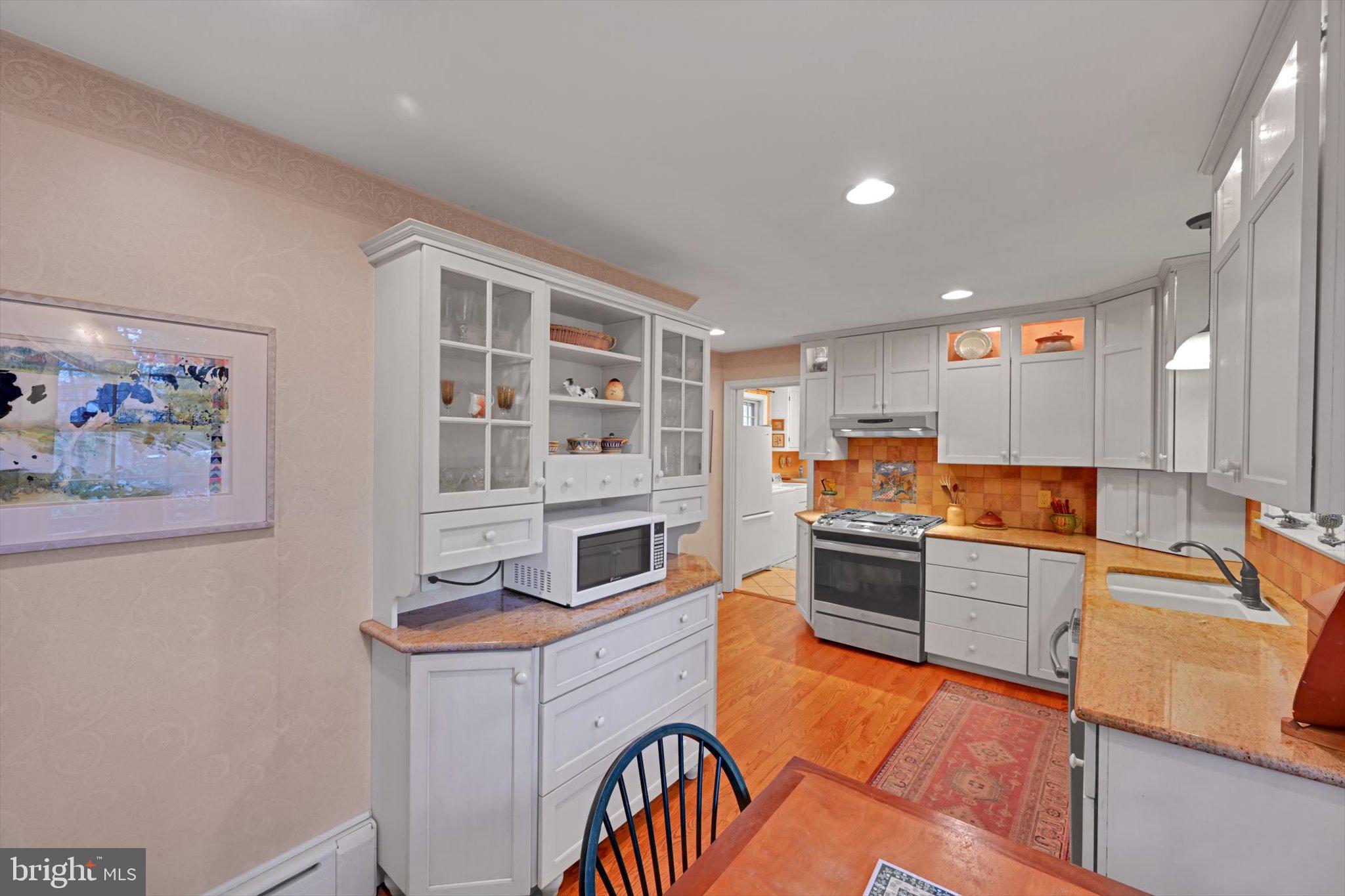411 Woodcrest Avenue Lititz, PA 17543 - Photo 11 of 38 a kitchen with stainless steel appliances granite countertop a stove and a refrigerator