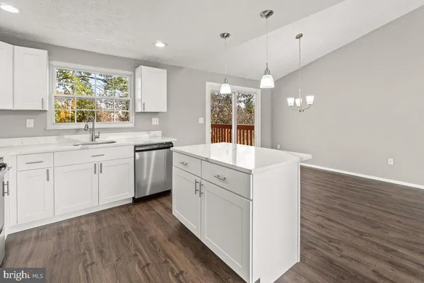a kitchen with a sink window and cabinets