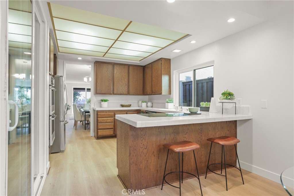 637 Avery Place Long Beach, CA 90807 - Photo 9 of 19 a kitchen with stainless steel appliances granite countertop a stove and a refrigerator