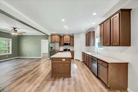 a kitchen with stainless steel appliances granite countertop a sink stove and wooden floor