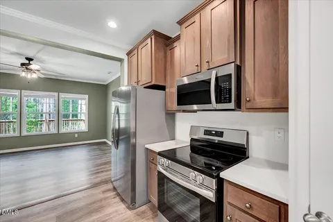 a kitchen with stainless steel appliances a stove a microwave and a sink