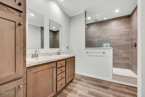 a bathroom with a double vanity sink a mirror and a shower