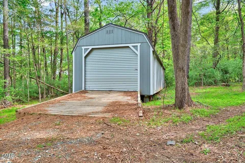 a view of a garage with wooden fence