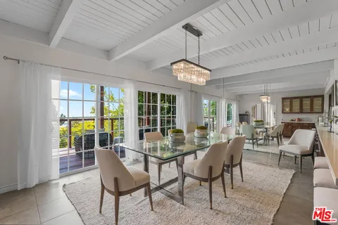 a dining room with furniture a chandelier and a rug