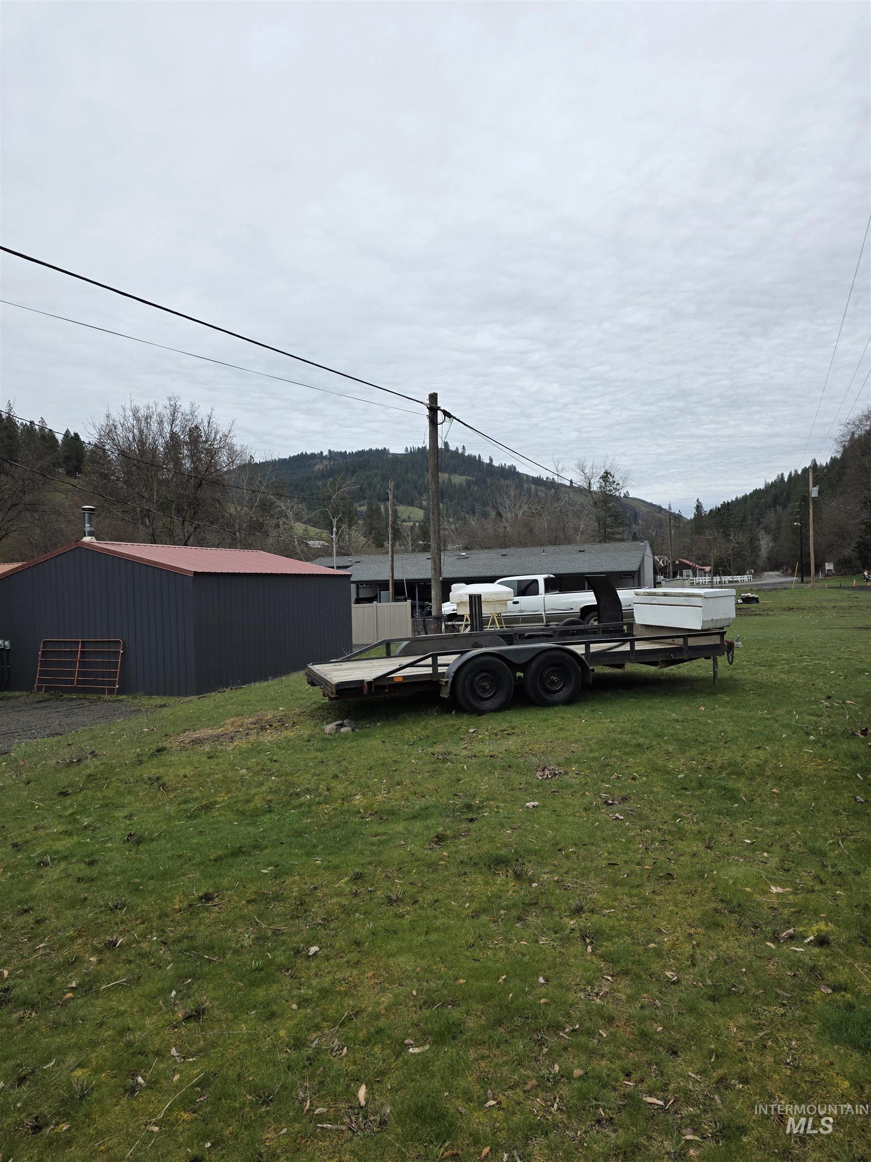 220 South Main Street Peck, ID 83545 - Photo 6 of 15 View of green lawn with an outdoor structure and a pole building