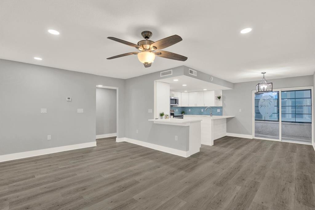337 Rex Place, Unit A Madeira Beach, FL 33708 - Photo 8 of 48 a view of a kitchen with wooden floor and a sink