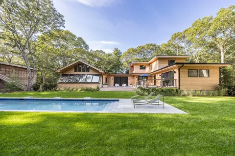 a front view of a house with a yard table and chairs