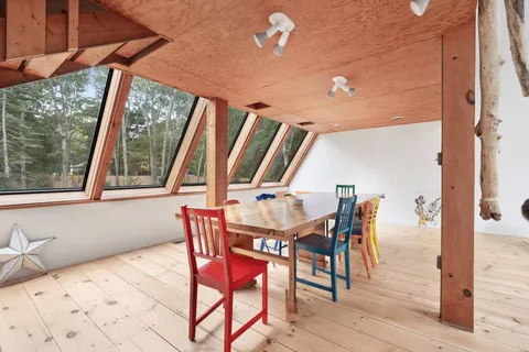 a dining room with furniture and wooden floor