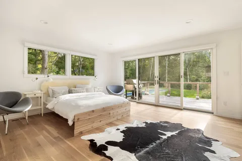 a spacious bedroom with a bed and a couch