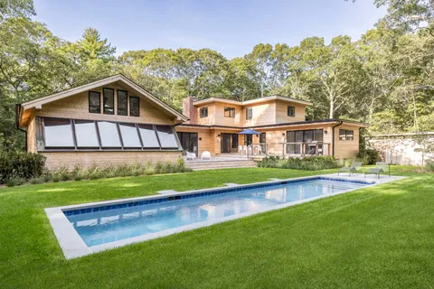 a front view of houses with yard and green space