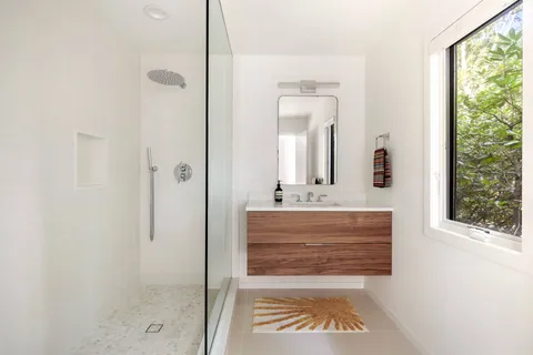 a bathroom with a shower and a sink