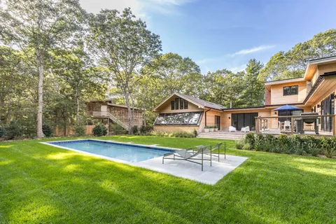 a view of house with outdoor seating and yard