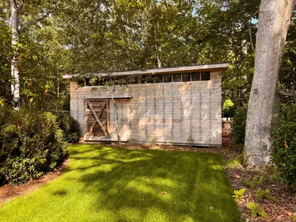 a view of a back yard with a wooden fence