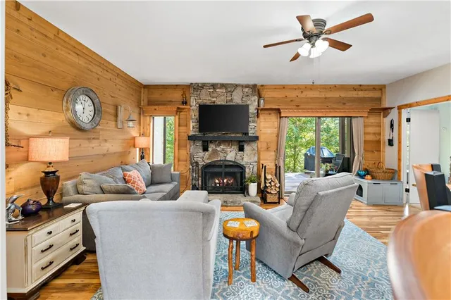 a living room with furniture a fireplace and a flat screen tv