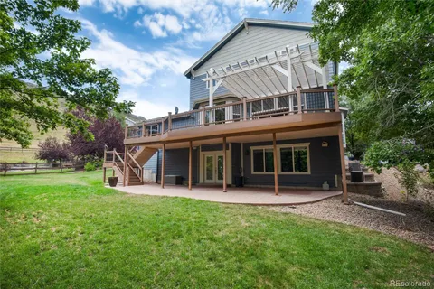 a living room with furniture kitchen view and a chandelier