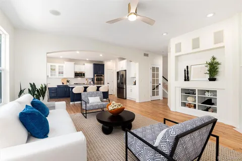 a living room with furniture large window and a fireplace
