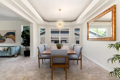 a view of a dining room with furniture and chandelier
