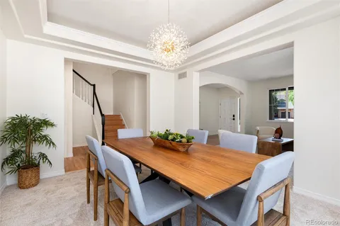 a large kitchen with kitchen island granite countertop a dining table chairs and a refrigerator