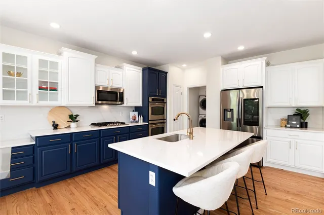 a kitchen with granite countertop wooden cabinets and stainless steel appliances