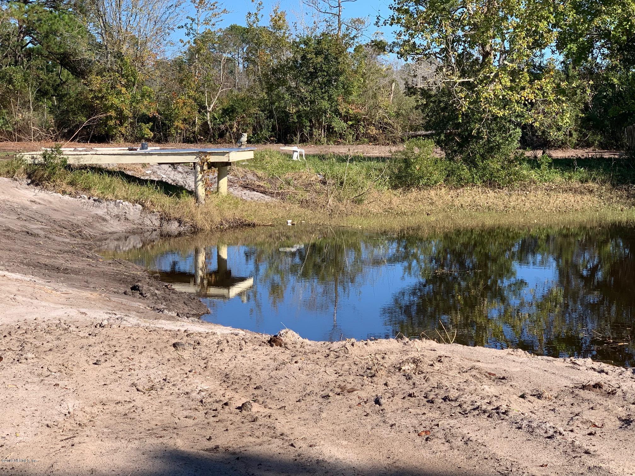10451 Sawpit Road Jacksonville, FL 32226 - Photo 16 of 37 a view of a backyard of water with a large tree