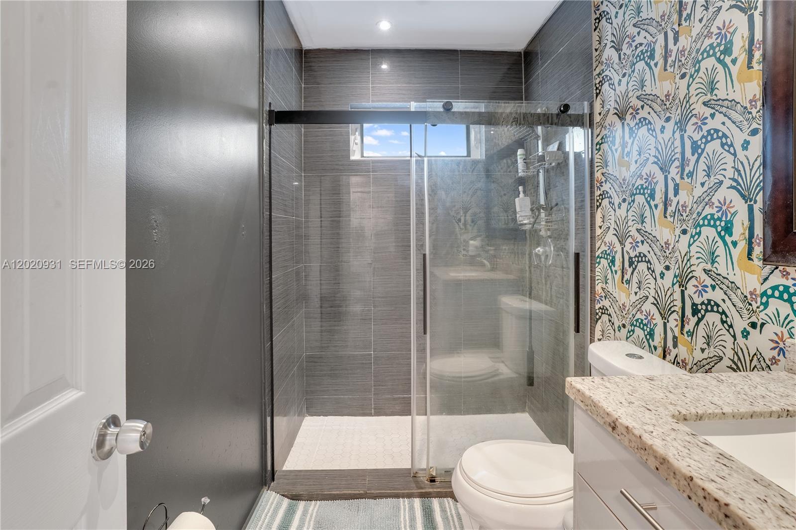 1360 Northwest 77th Street Miami, FL 33147 - Photo 14 of 41 a bathroom with a granite countertop sink toilet and shower