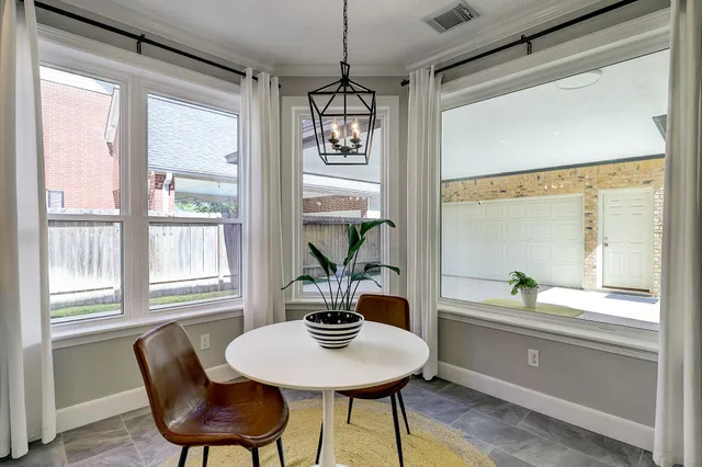a dining room with furniture a chandelier and wooden floor