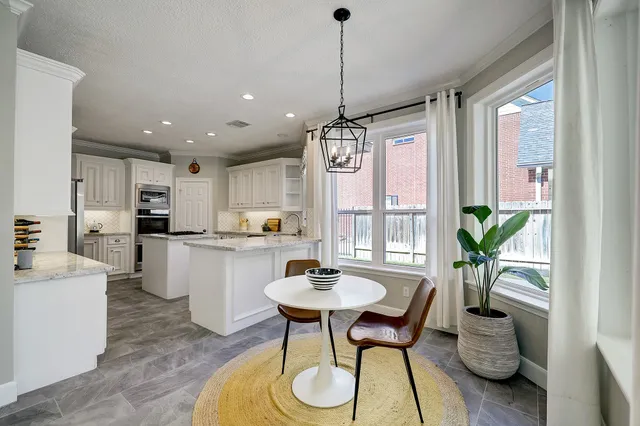 a dining room with furniture and window