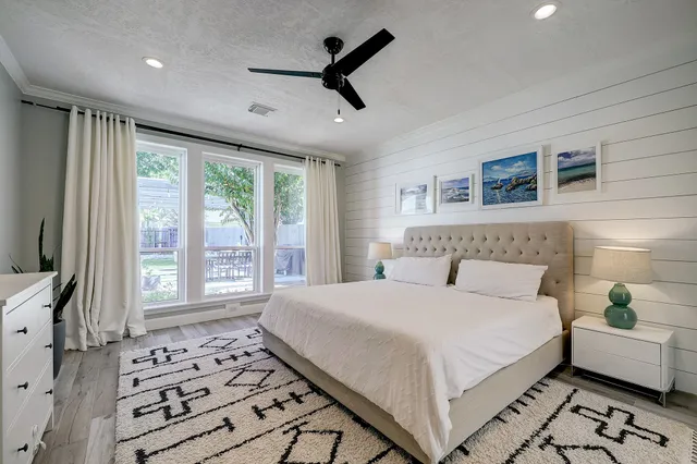 a spacious bathroom with a granite countertop sink mirror and a bathtub