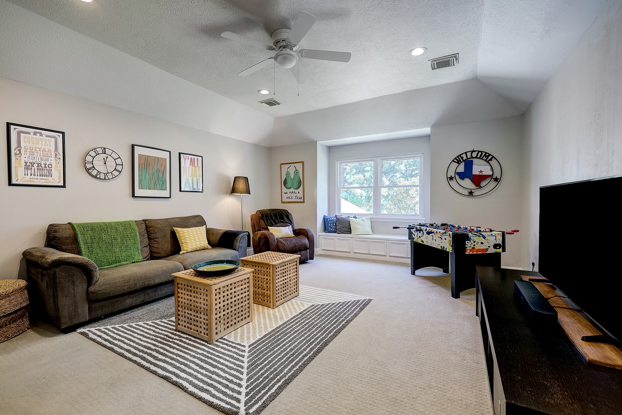 18902 Mountain Spring Drive Spring, TX 77379 - Photo 23 of 32 a living room with furniture a rug and a flat screen tv