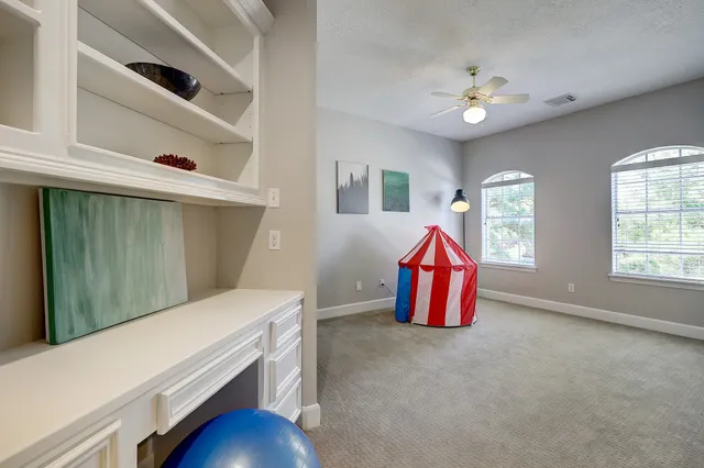 a bathroom with a granite countertop sink a toilet a mirror a bathtub and shower