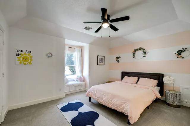 a bedroom with a bed and a window