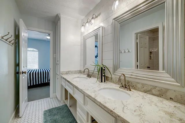 a view of a patio with table and chairs potted plants and large tree