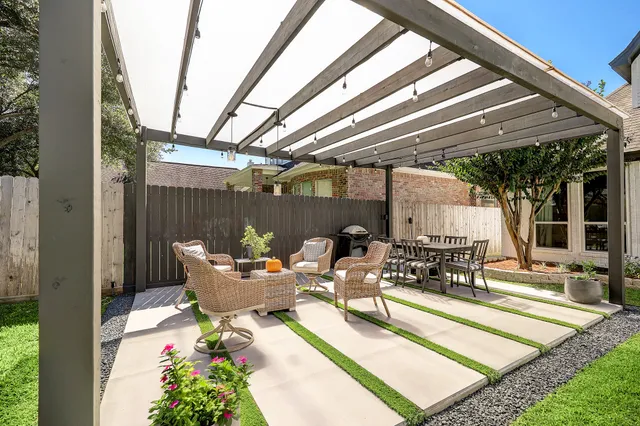 a view of a house with backyard porch and sitting area
