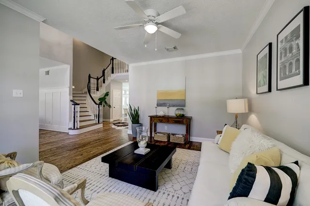 a living room with furniture and wooden floor
