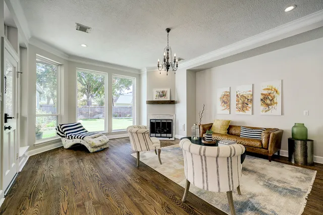 a living room with furniture fireplace and window