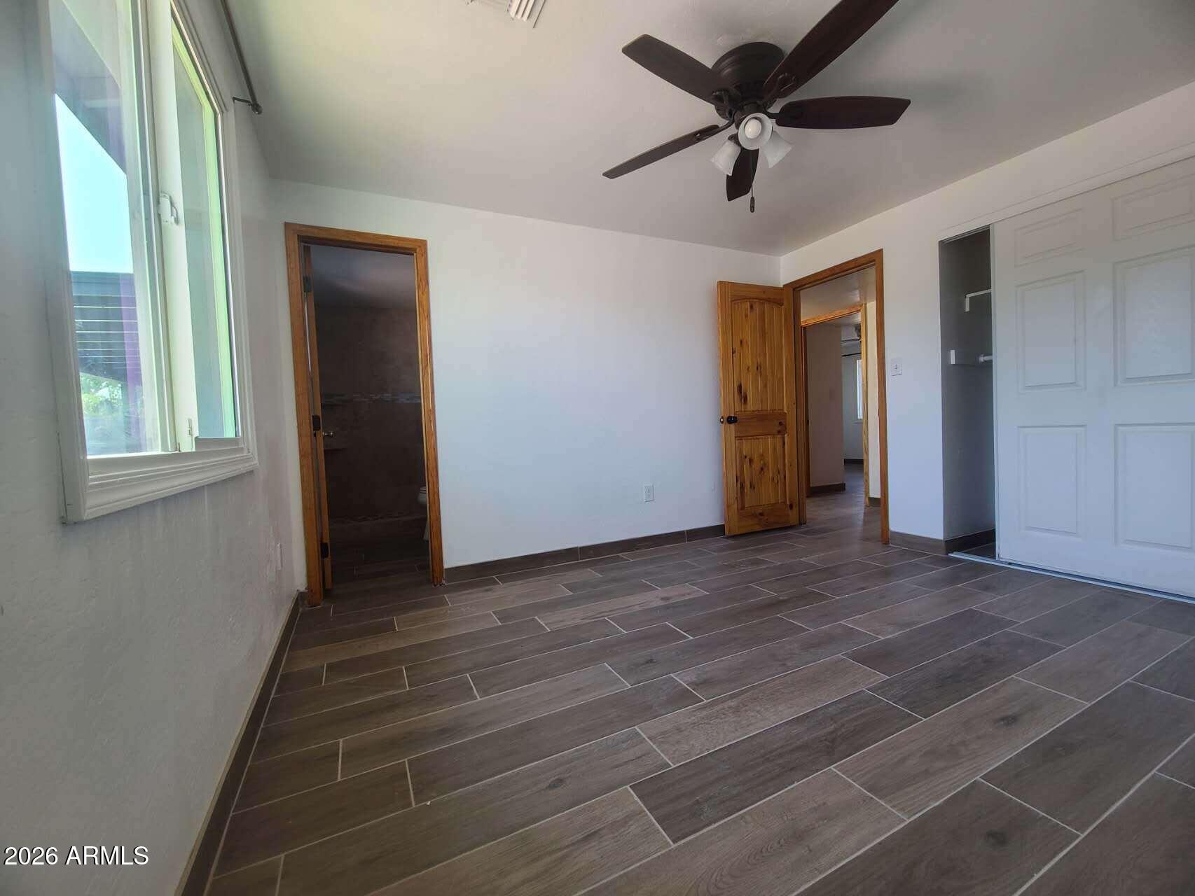 3702 East Thunderbird Road Phoenix, AZ 85032 - Photo 17 of 23 a view of a livingroom with a ceiling fan and window
