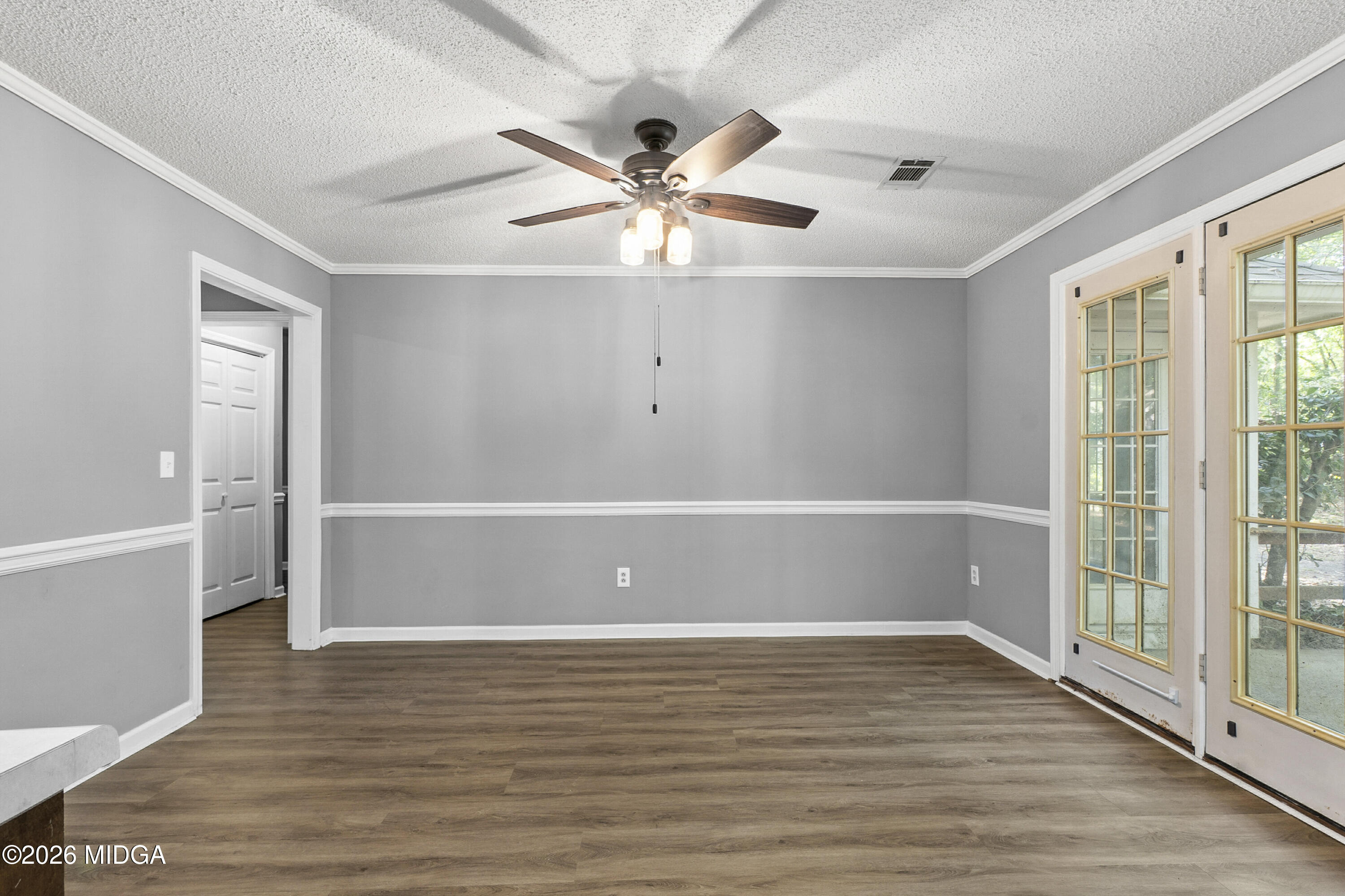 5626 Janeru Circle Macon, GA 31216 - Photo 14 of 45 a view of an empty room with wooden floor and a window
