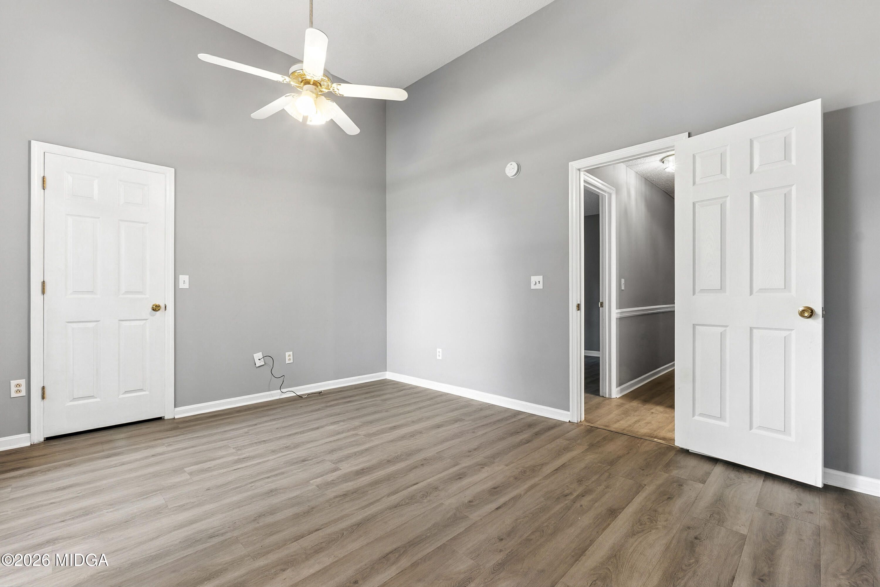 5626 Janeru Circle Macon, GA 31216 - Photo 17 of 45 an empty room with wooden floor and a ceiling fan