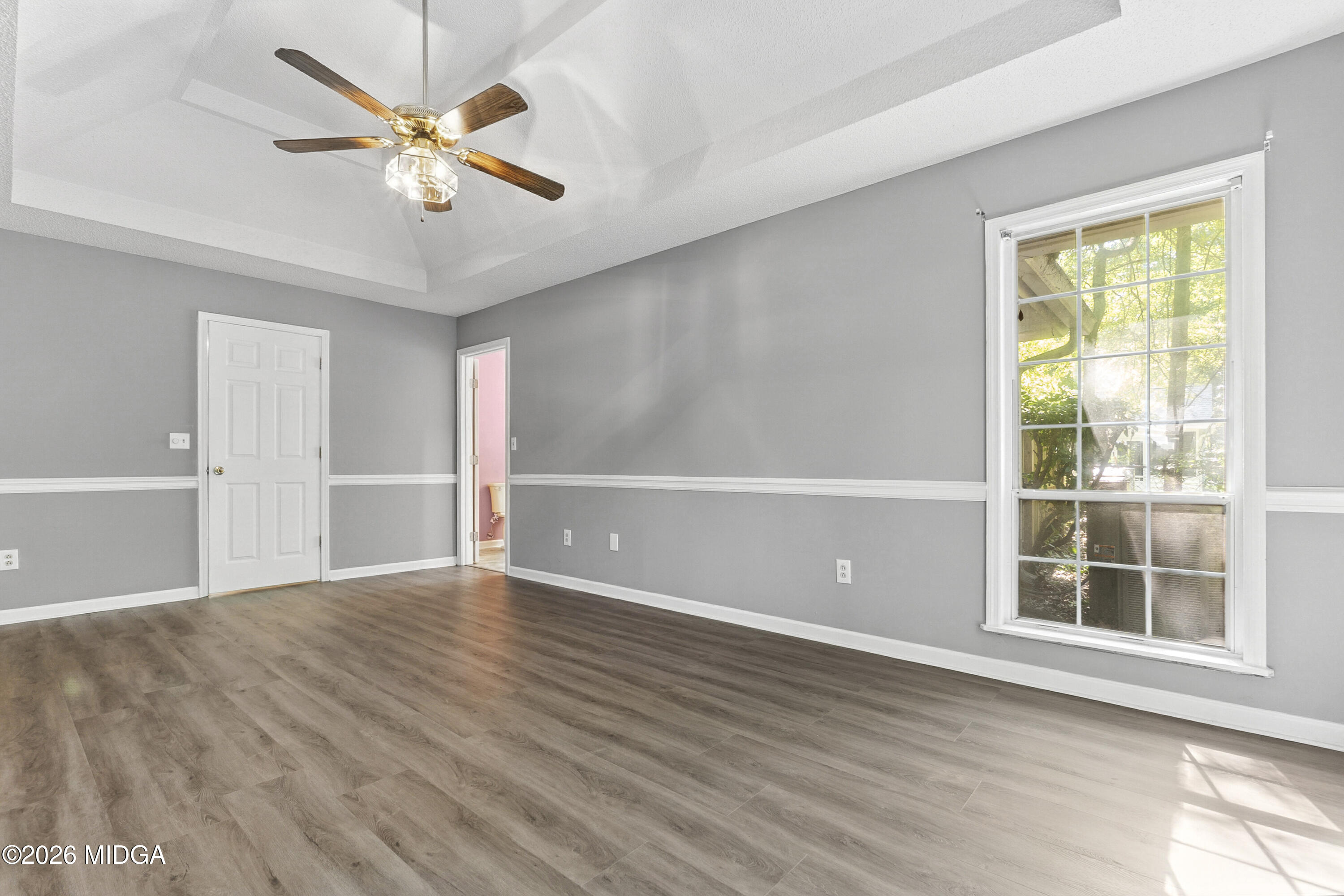 5626 Janeru Circle Macon, GA 31216 - Photo 29 of 45 a view of an empty room with a window and wooden floor