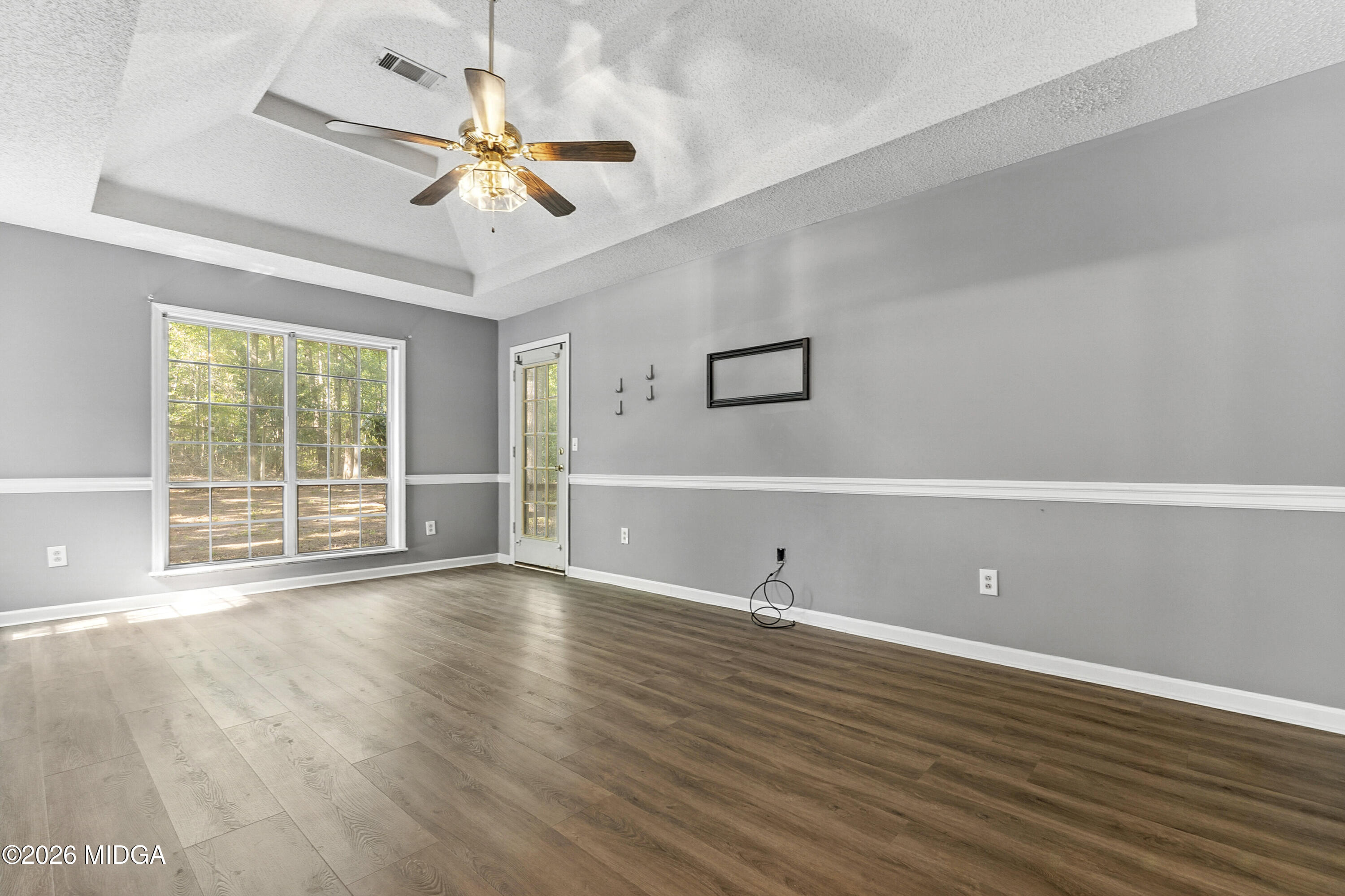 5626 Janeru Circle Macon, GA 31216 - Photo 30 of 45 a view of an empty room with wooden floor and a window