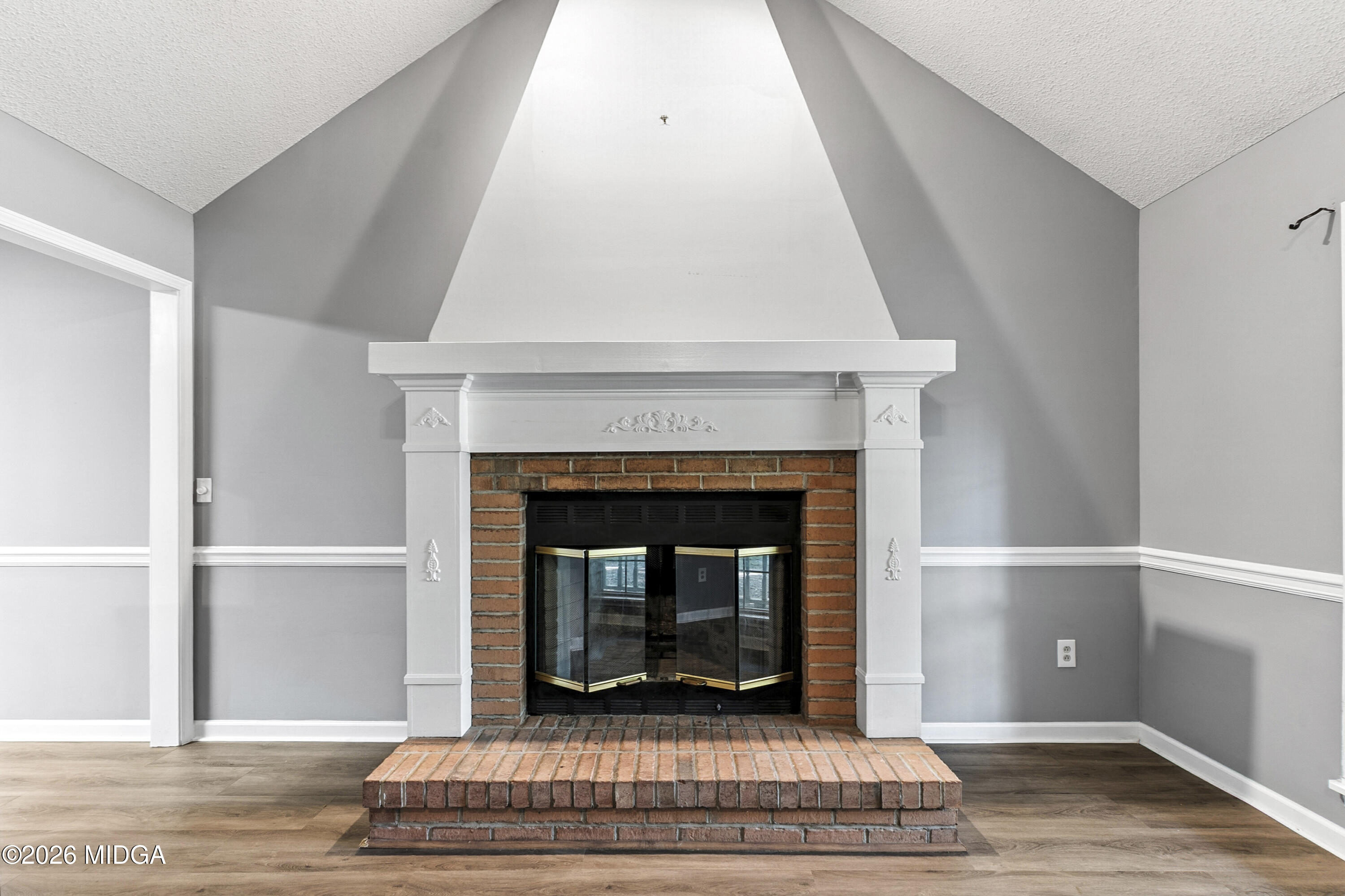 5626 Janeru Circle Macon, GA 31216 - Photo 5 of 45 a living room with a fireplace and a rug